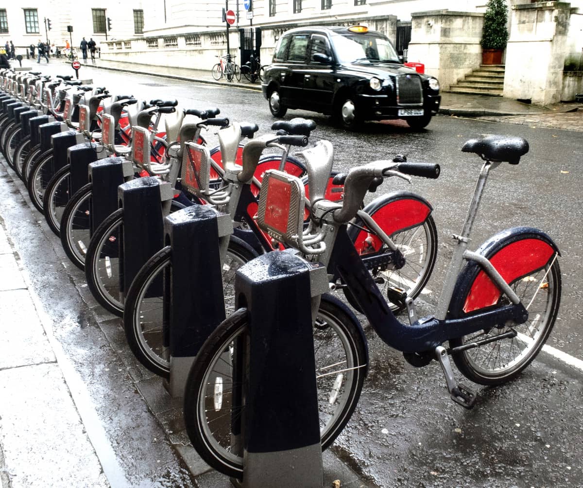 Row of locked bikes on a rainy London street