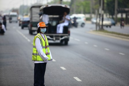 person directing traffic wearing a face mask